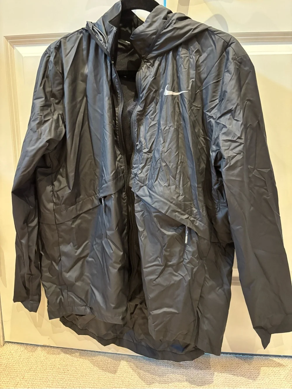 Nike Black Hooded Rain Jacket with Reflective Swoosh. Longer in back, hood.